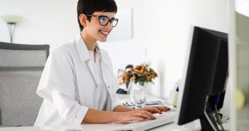 A doctor using a computer to read medical data.