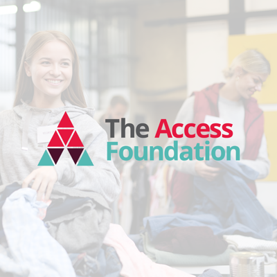 Two women sorting clothes at a donation event, with ‘The Access Foundation’ logo in the foreground