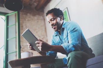 A man reviewing his wellbeing data on a tablet device.