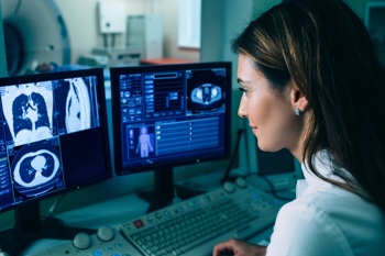 A consultant looking at patient scans within their health record.