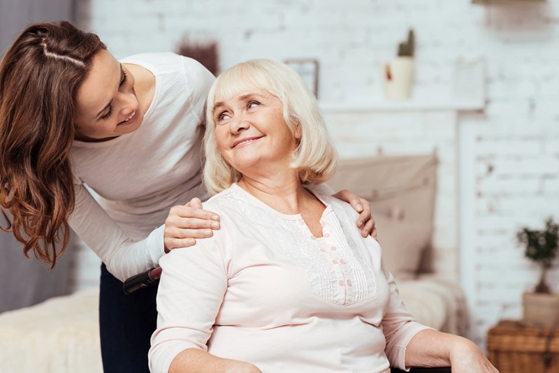 an image of a carer supporting an older woman to show quality and accessibility of social care