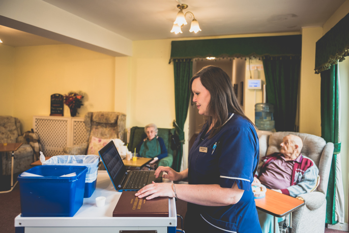 care worker using a laptop