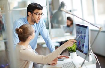 Man and women looking at procurement software
