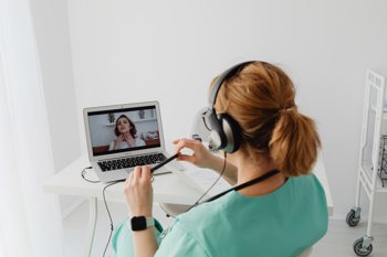 Image of a woman having an online assessment to review the voice of the child