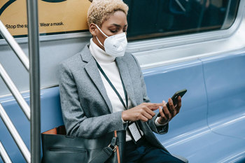 Lady wearing mask commuting on the train