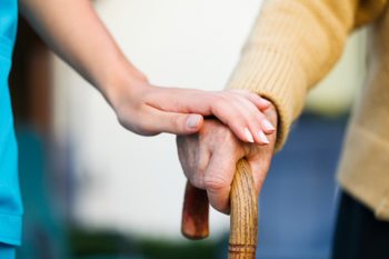 Hands illustrating electronic care plans for care homes