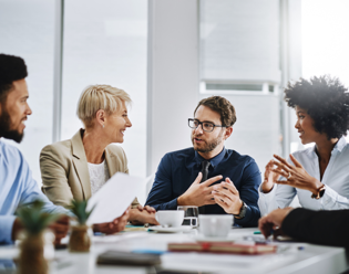 people in meeting discussing learning strategies