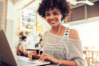 A student smiling while she works.