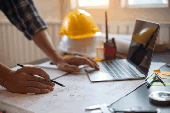 Construction worker reviewing plans on construction site