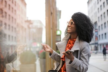 Young woman holding phone looking happy