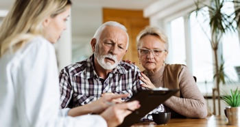 Man and wife meet to talk with a doctor.