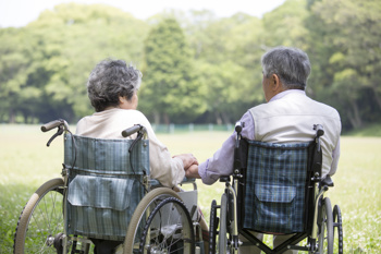 Two people sitting in wheel chairs