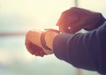 An image of a man using a telecare watch to promote preventative care as a way to reduce admissions