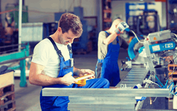 Engineer examining work in factory