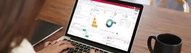 lady looking at brokerage graphs on laptop