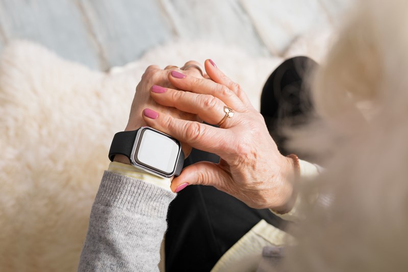 an image of a lady using a watch detection device to show how actionable insights work in social care