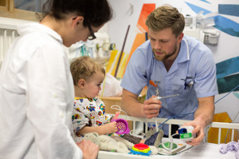 paediatrician consulting baby with mother