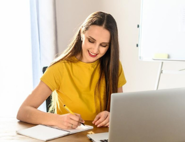 Happy women on laptop looking at Access Dimensions