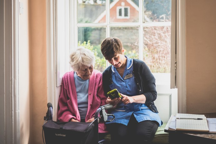 care worker sitting with an old lady