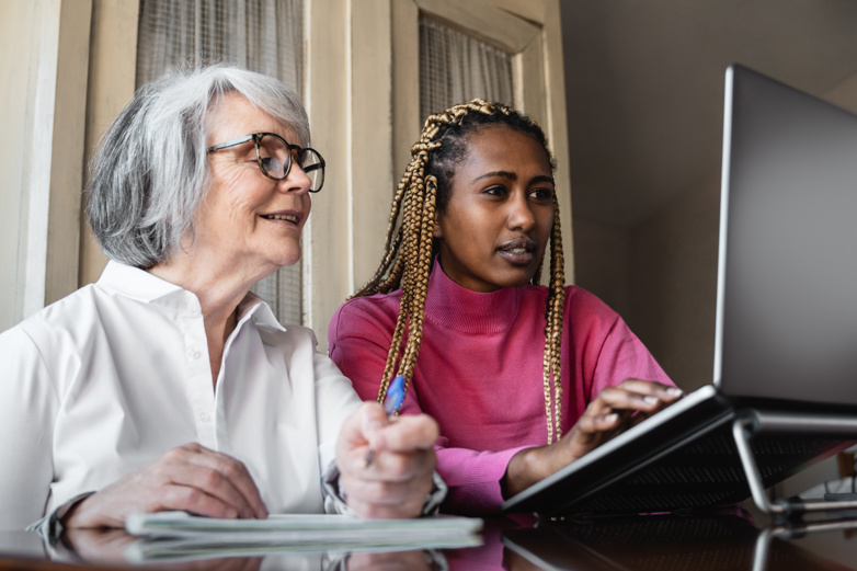 two women looking at a laptop