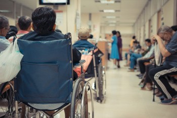 Reasons for delayed hospital discharge, featuring a busy waiting room.