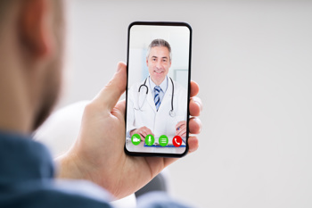 A patient receiving a video call from a GP via their smartphone.