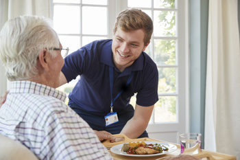 Carer talking to old man