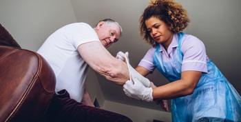 A virtual ward home appointment for a district nurse to change a patient's dressing.