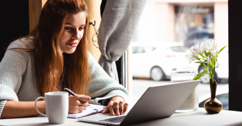 a person using a laptop for CQC compliance and procedures