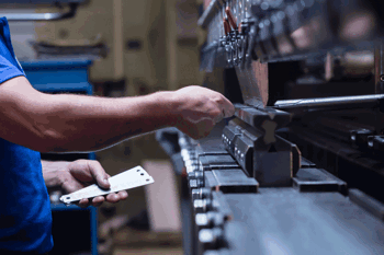 Factory worker using heavy machinery