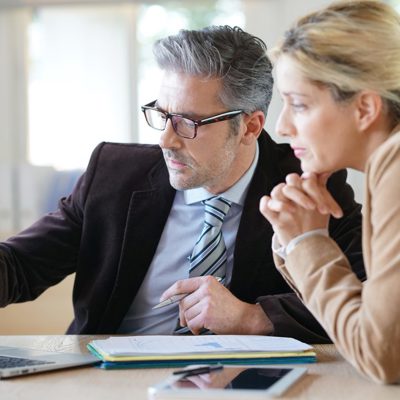 A man and a woman looking at a laptop