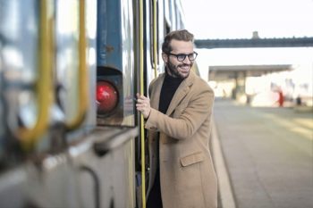 Young man getting on train