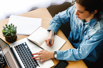 Lady writing on a notepad