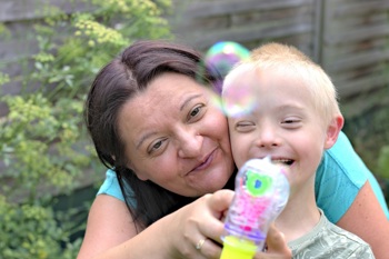 A woman caring for a disabled child.