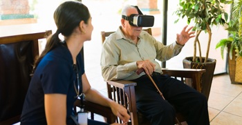 A nurse helping a patient use a virtual reality headset for healthcare.