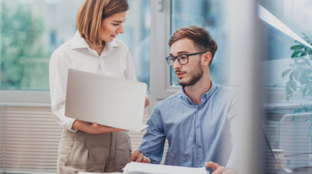 two people discussing CQC policies and procedures