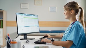 A nurse inputting data into an electronic health record.