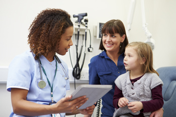 Doctor talking to child and mother