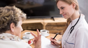 A doctor performing a questionnaire with a patient.