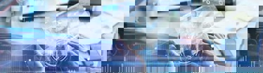 Image of finance data over employee working on laptop