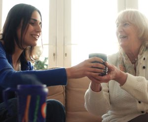 Care provider handing a cup to a patient