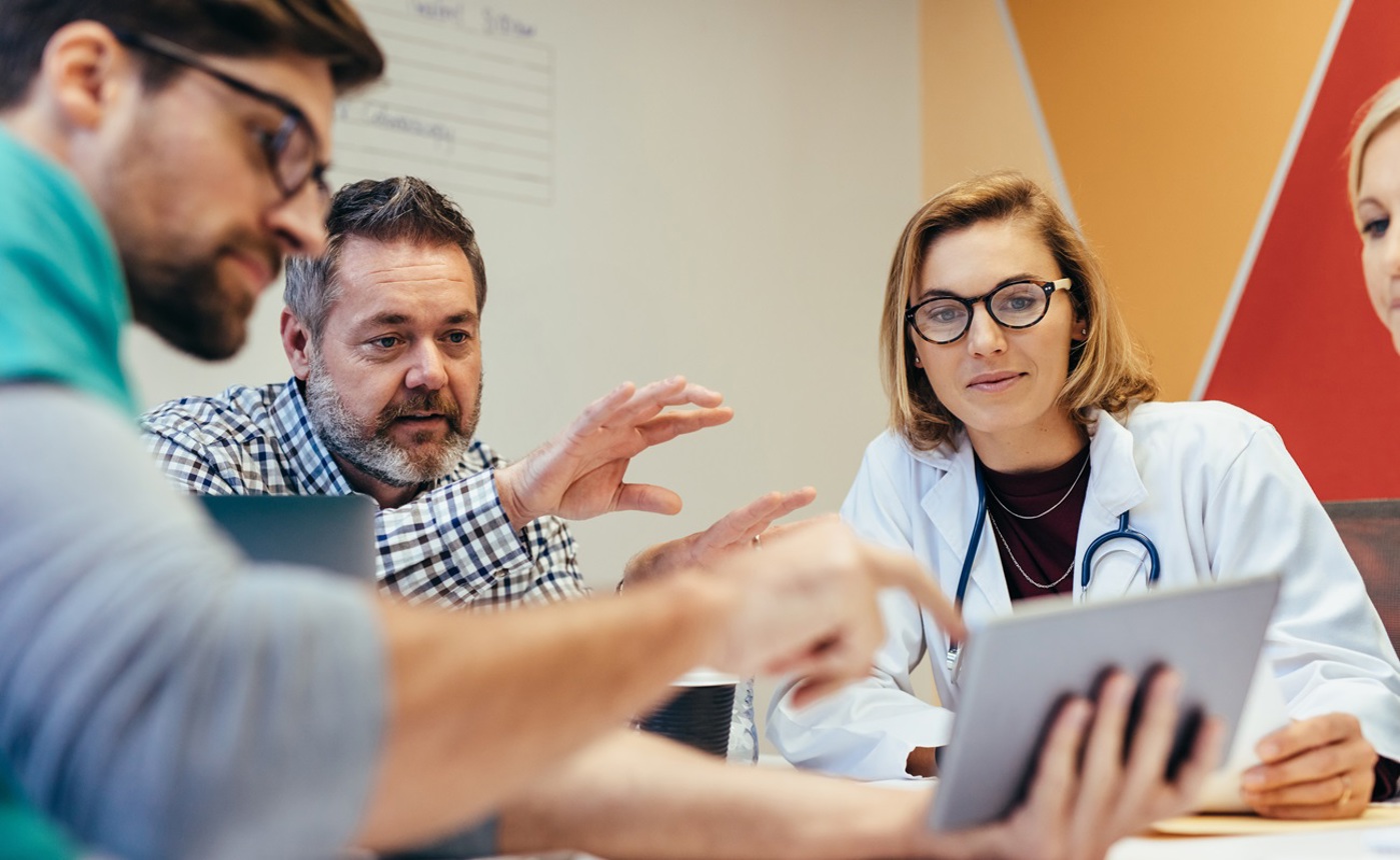 Enlarged Doctors collaborating on work.