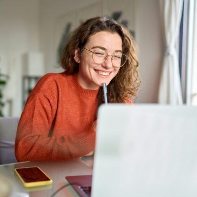 woman smiling at laptop