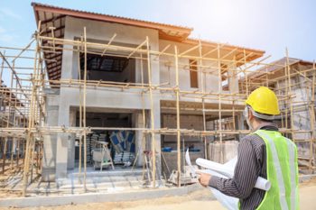 Builder looking at construction of a house