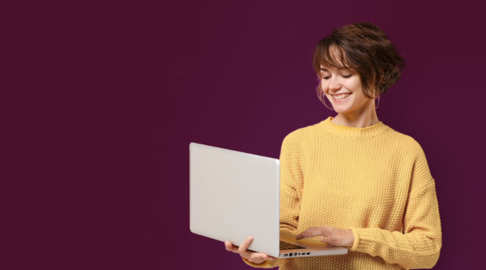 Woman With Laptop On Purple Background 