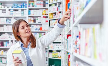 Pharmacist packing medication order from care home