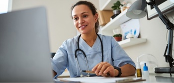 A nurse using a hospital computer to access electronic medical records.