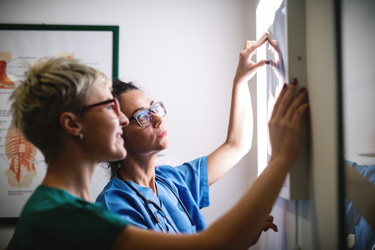Two doctors looking at an X-ray image