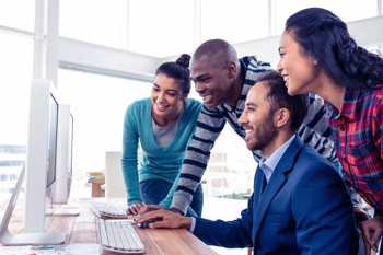 Group of workers looking at a screen