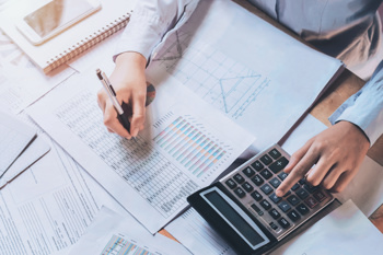 An image of a woman working our finances to show an SEN Personal budget